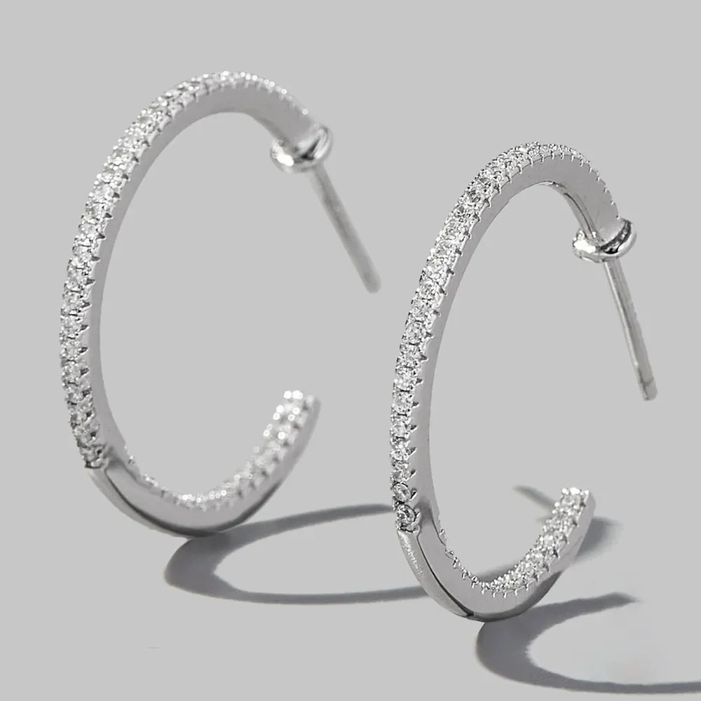 Silver pavé zirconia half-hoop earrings in 925 sterling silver.