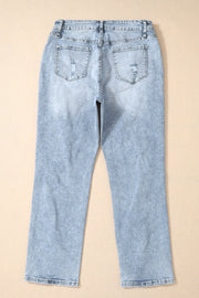 Distressed wash light blue denim slim leg jeans with ripped back pockets.