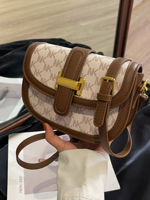 Chic monogrammed flap crossbody bag in Rice White with brown trim and gold hardware.
