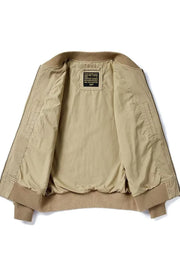 Khaki bomber jacket with ribbed cuffs and hem, featuring a patch detail on the inside label.