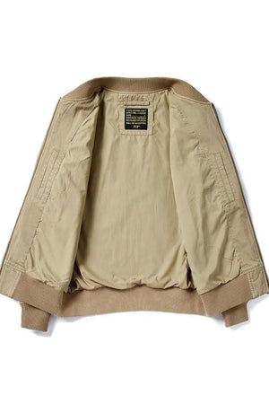 Khaki bomber jacket with ribbed cuffs and hem, featuring a patch detail on the inside label.