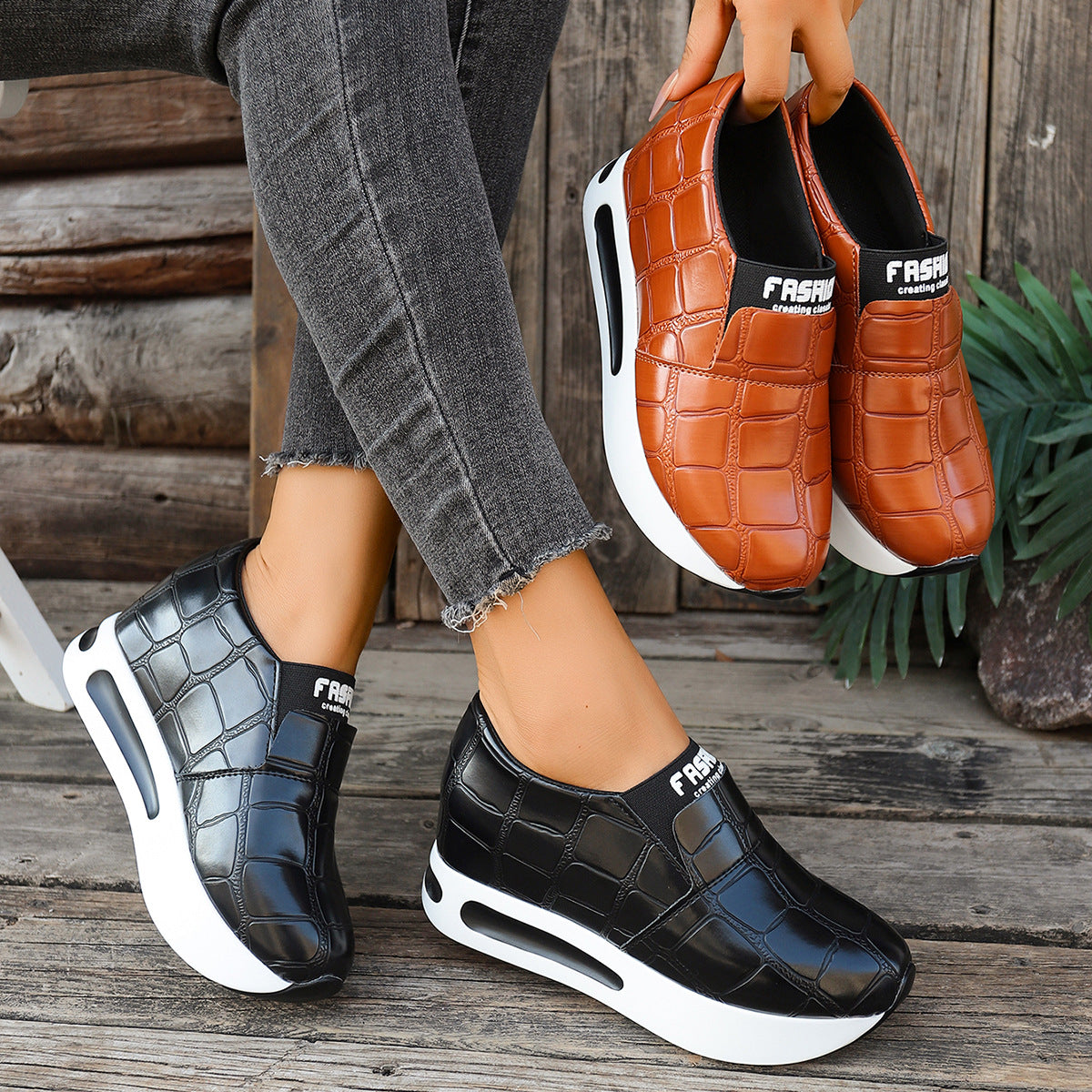 Black crocodile pattern platform slip-on shoes with chunky sole.