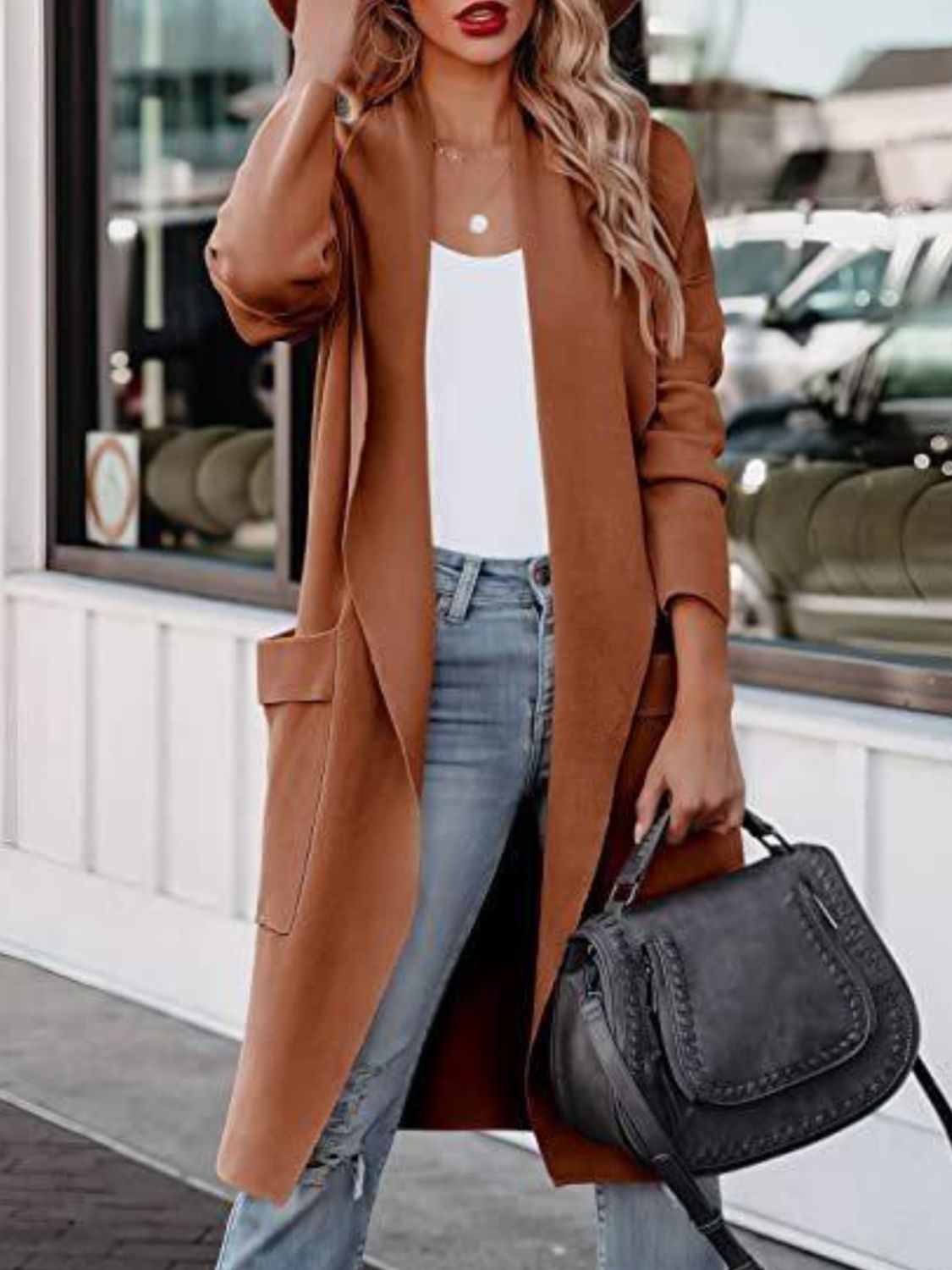 Caramel open-front duster cardigan with pockets, worn over a white top and jeans.