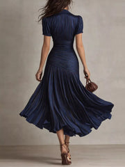 Navy ruched midi dress with pleated skirt and subtle pinstripes.