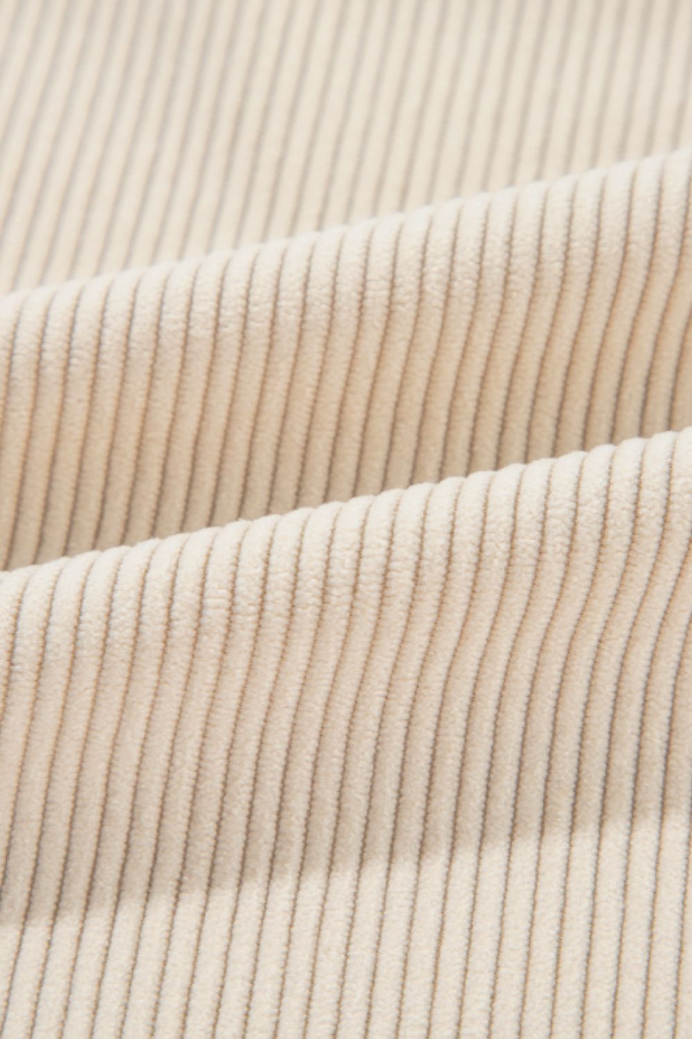 Beige corduroy shacket fabric detail with vertical wales.