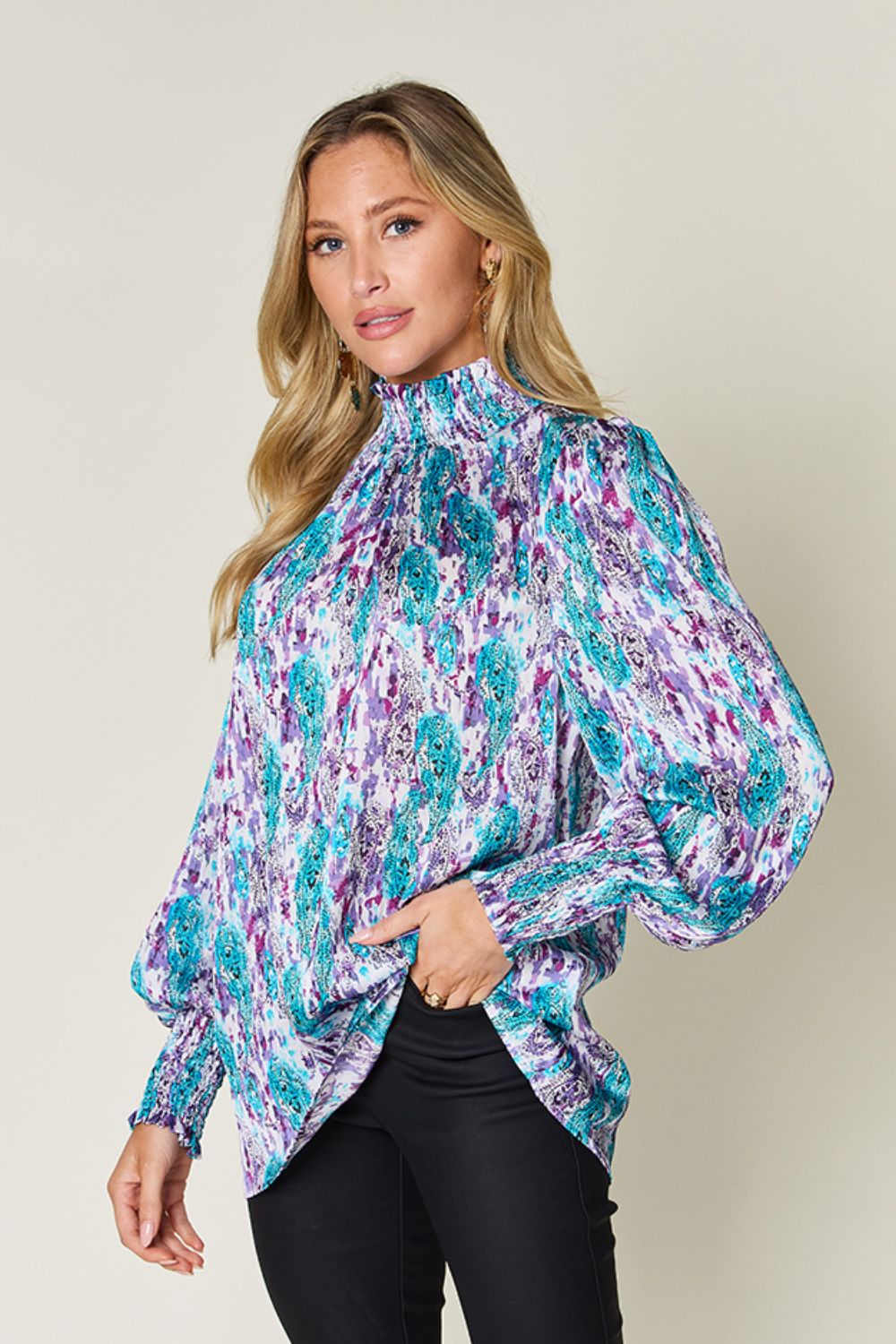 High neck abstract print blouse in sky blue and red-violet with smocked cuffs.