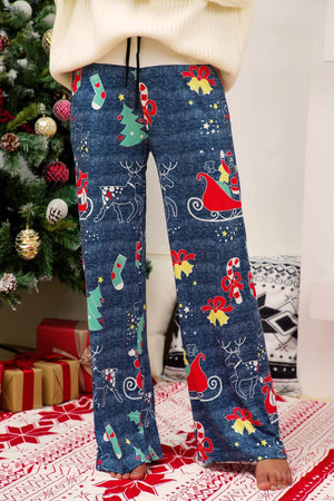 Festive print wide-leg lounge trousers in blue with Christmas motifs like Santa, reindeer, and trees.