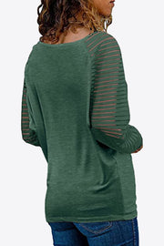 Mist Green raglan v-neck top with striped sleeves.