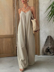 Effortless frill-trimmed sleeveless beige wide-leg jumpsuit with V-neck and spaghetti straps.