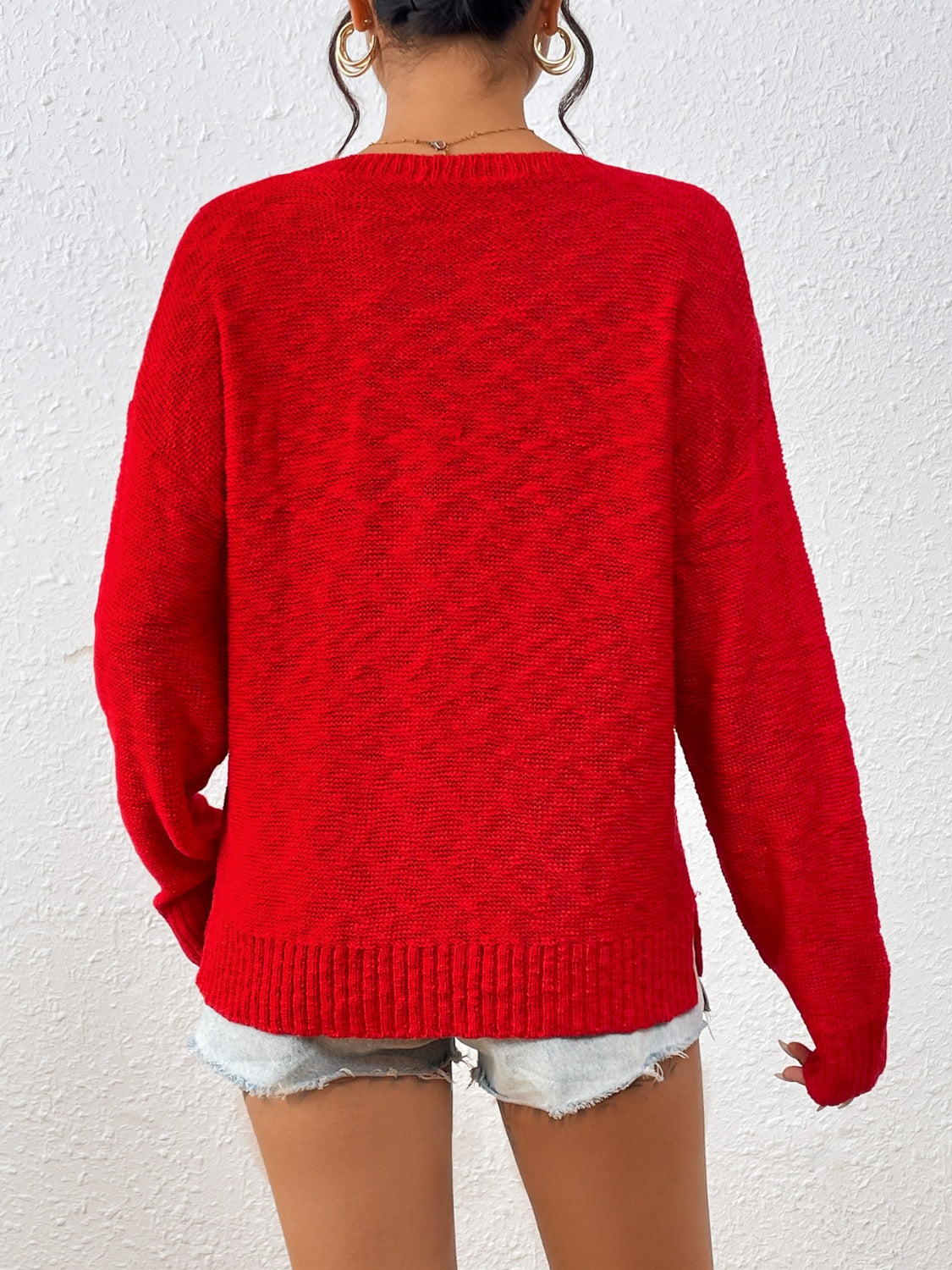 Deep Red acrylic knit sweater with crew neck and side slits, styled with denim shorts.