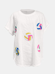 White t-shirt with colorful sequin volleyball graphics and rolled sleeves.