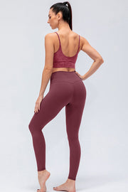 Burgundy high-rise performance leggings with V-shaped back seam detail.