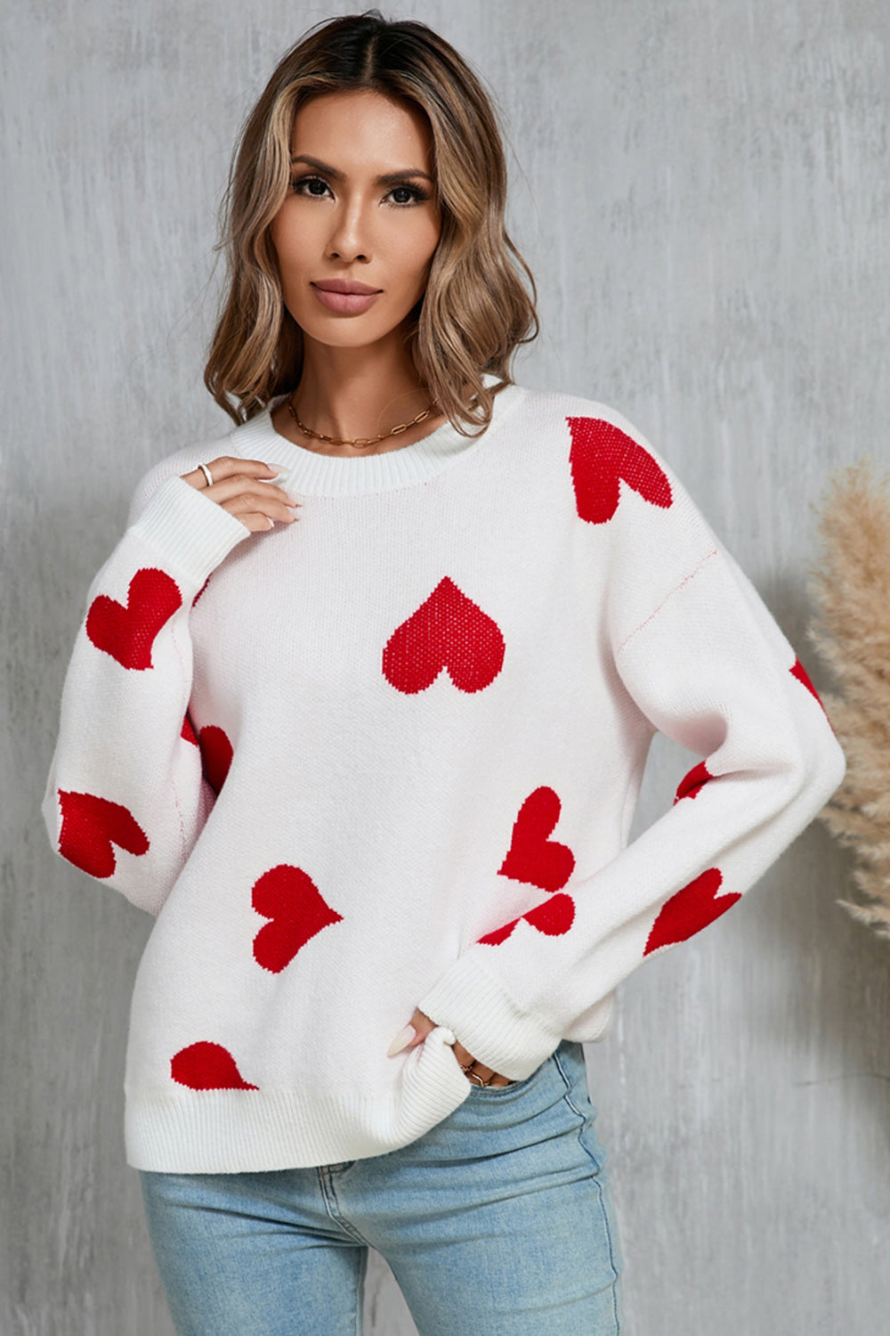 White acrylic knit jumper with red intarsia hearts, crew neck, long sleeves.