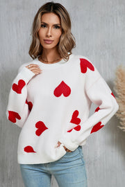 White acrylic knit jumper with red intarsia hearts, crew neck, long sleeves.