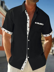 Black waffle textured button-up shirt with bird print trim and short sleeves