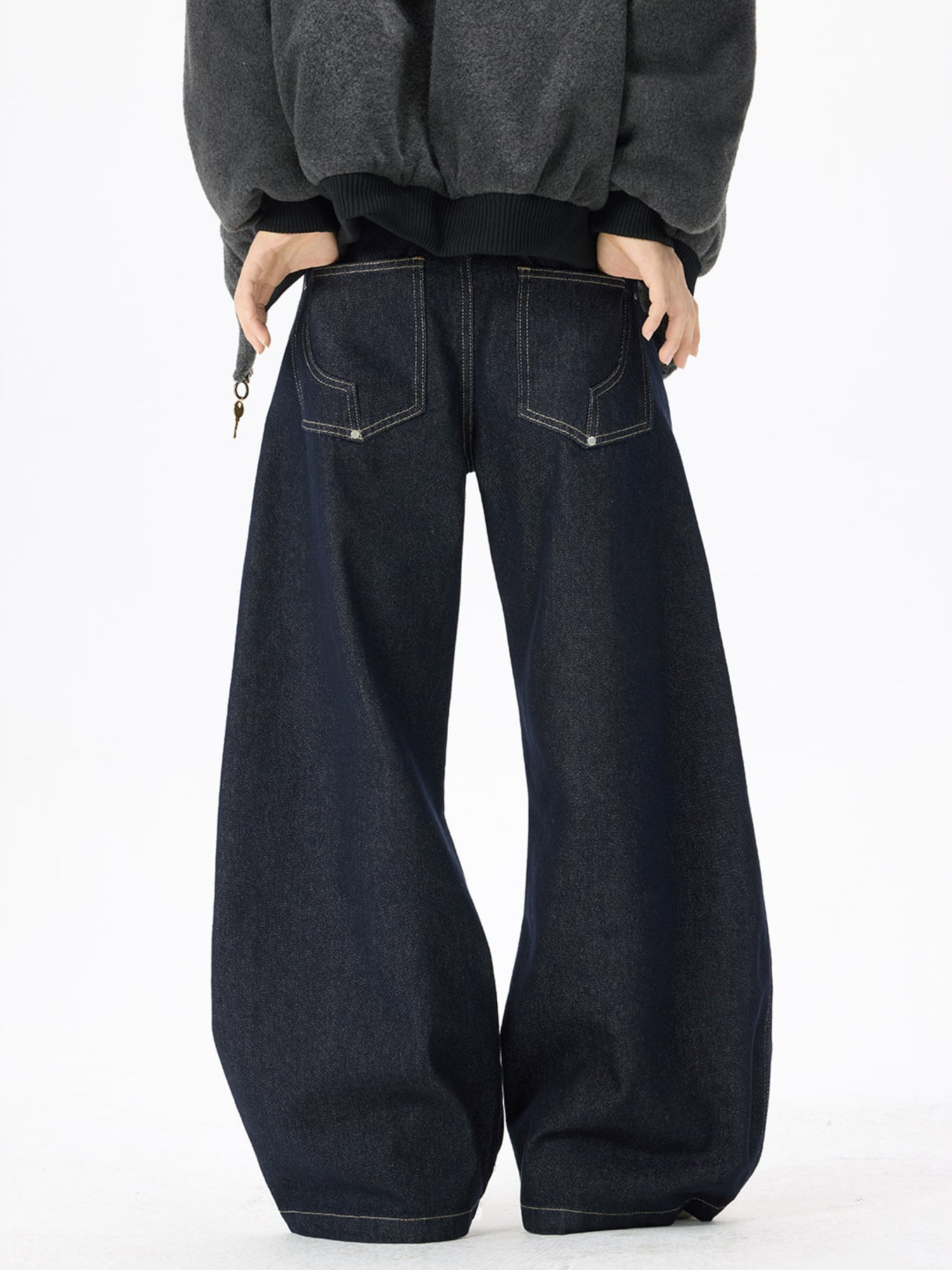 Exaggerated wide-leg dark wash denim jeans with contrast stitching and back pockets.