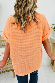 Waffle knit t-shirt in sherbet orange with cuffed short sleeves.