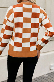 Off-shoulder knit pullover sweater in caramel and white checkerboard pattern with ribbed trim.