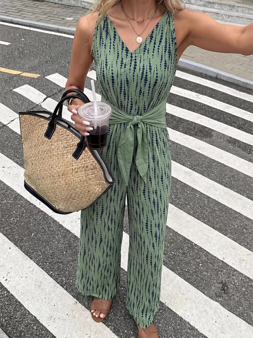 Green abstract print wide-leg jumpsuit with tie waist and V-neck