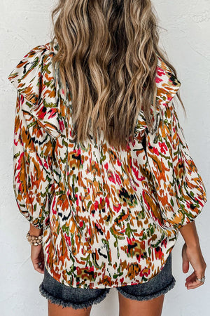 Ruffled Aura Sleeve Blouse in abstract print with ruffled shoulders and long sleeves.