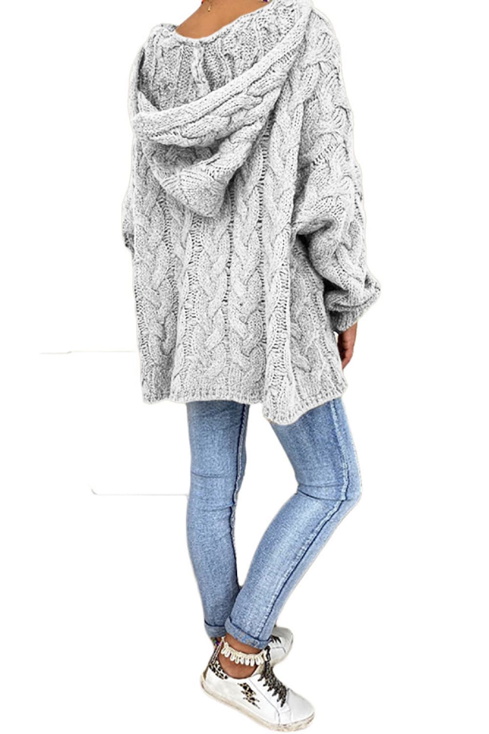 Light gray cable knit hooded cocoon sweater with a relaxed fit.