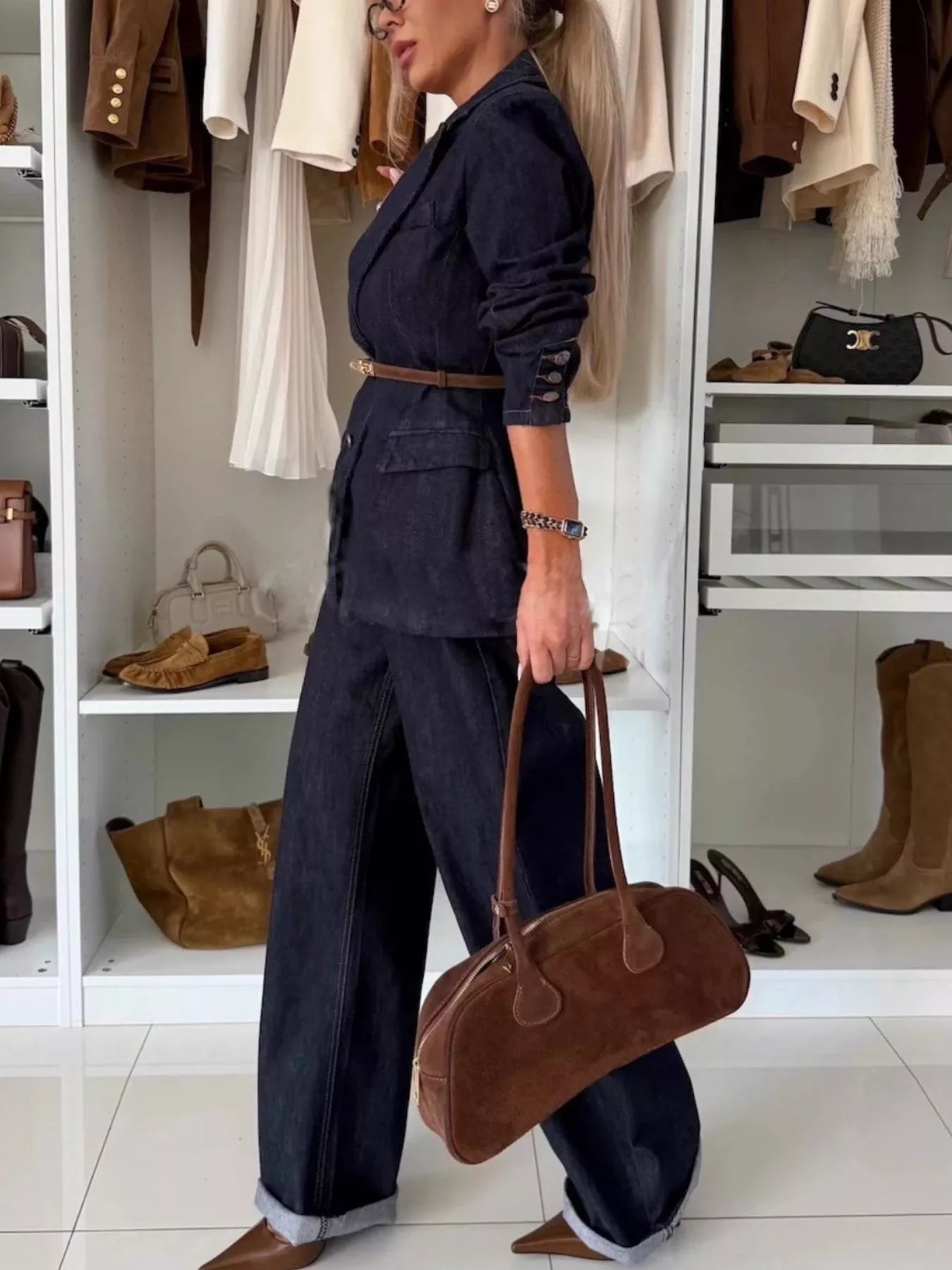 Dark blue denim double-breasted blazer and wide-leg pants, cinched with a brown belt.