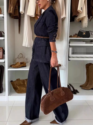 Dark blue denim double-breasted blazer and wide-leg pants, cinched with a brown belt.