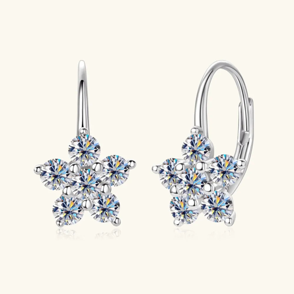 Celestial Cluster Huggie Hoops in silver feature a flower design with sparkling cubic zirconia stones.
