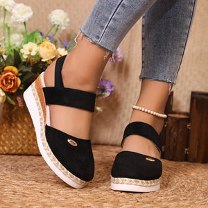 Black espadrille wedge slingback sandals with braided jute detail and ankle strap.