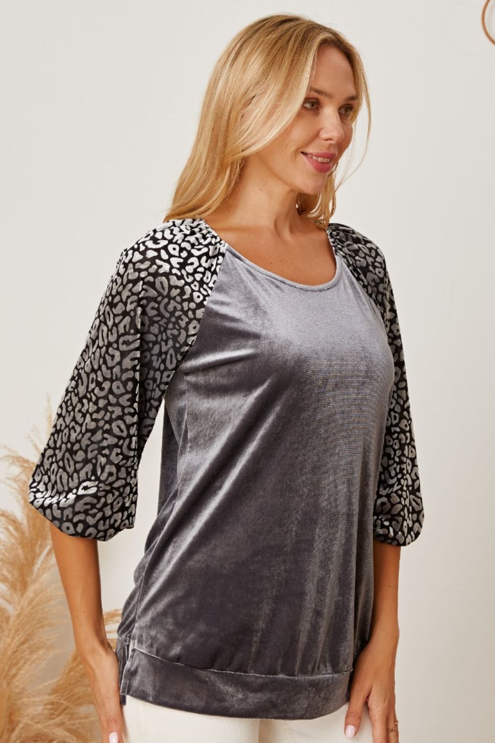 Velvet raglan top in dark gray with leopard print 3/4 sleeves and scoop neck.