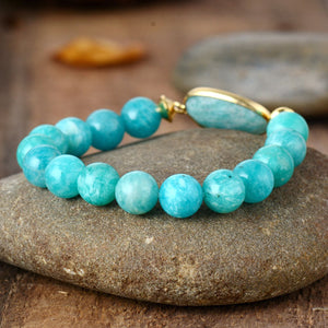 Aqua beaded bracelet with gold accent and stone orb detail