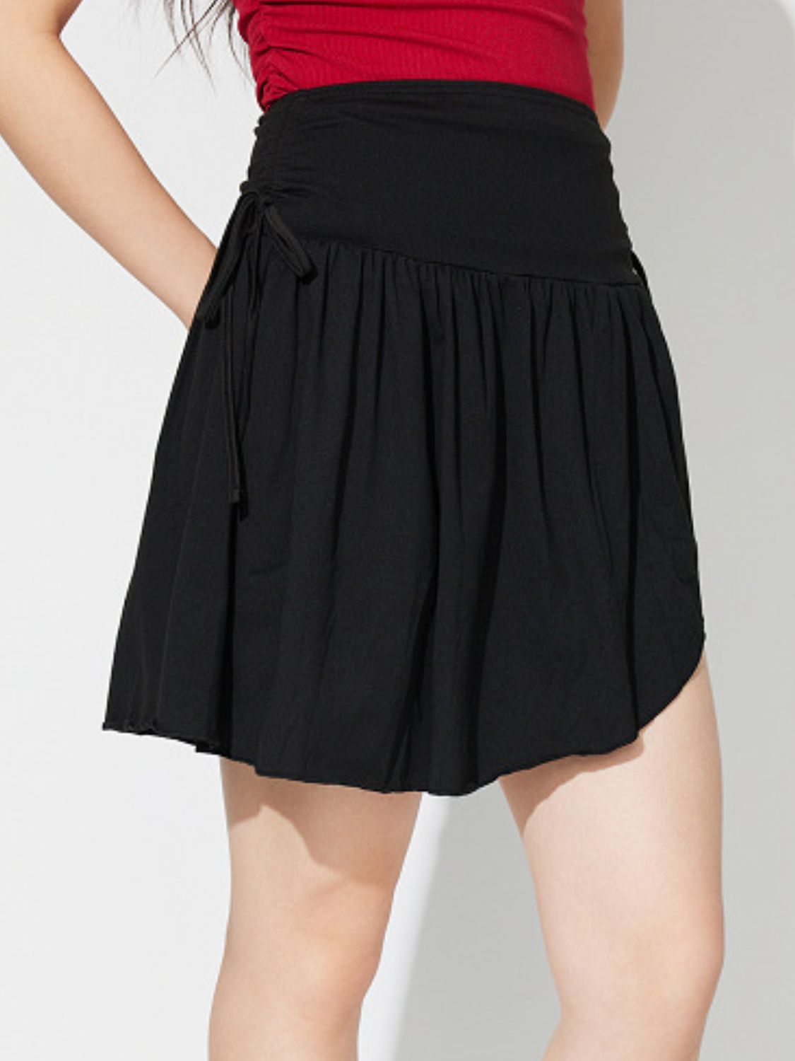 Black draped wrap mini skirt with tie detail and ruched waist