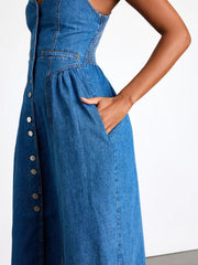 Denim midi dress with button front, smocked sides, and pockets.