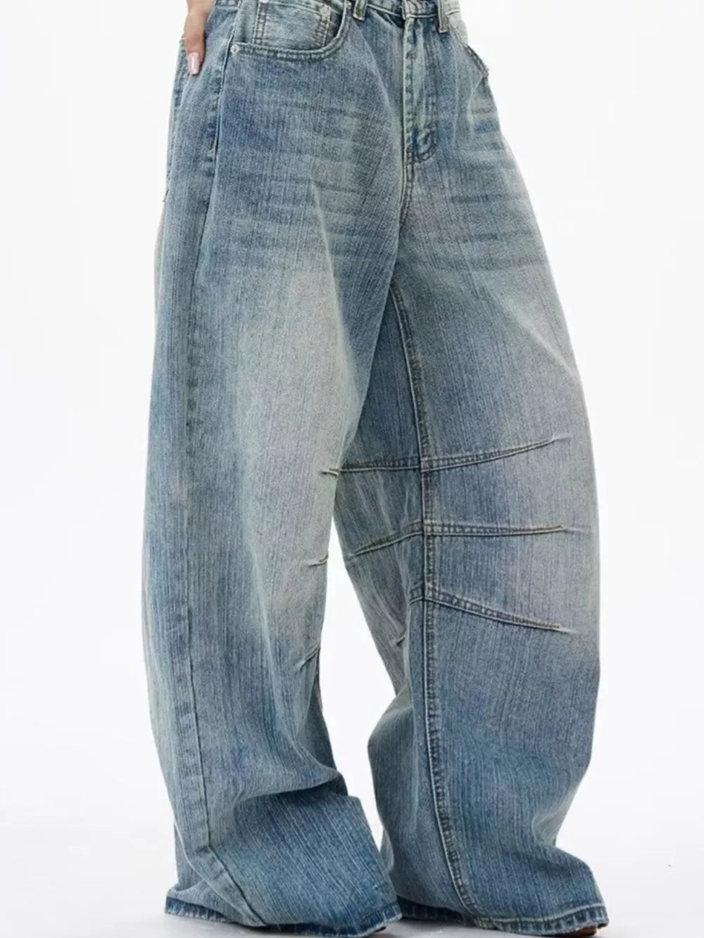 Men's light wash wide leg jeans with exaggerated fit and panel detailing.