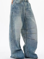 Men's light wash wide leg jeans with exaggerated fit and panel detailing.
