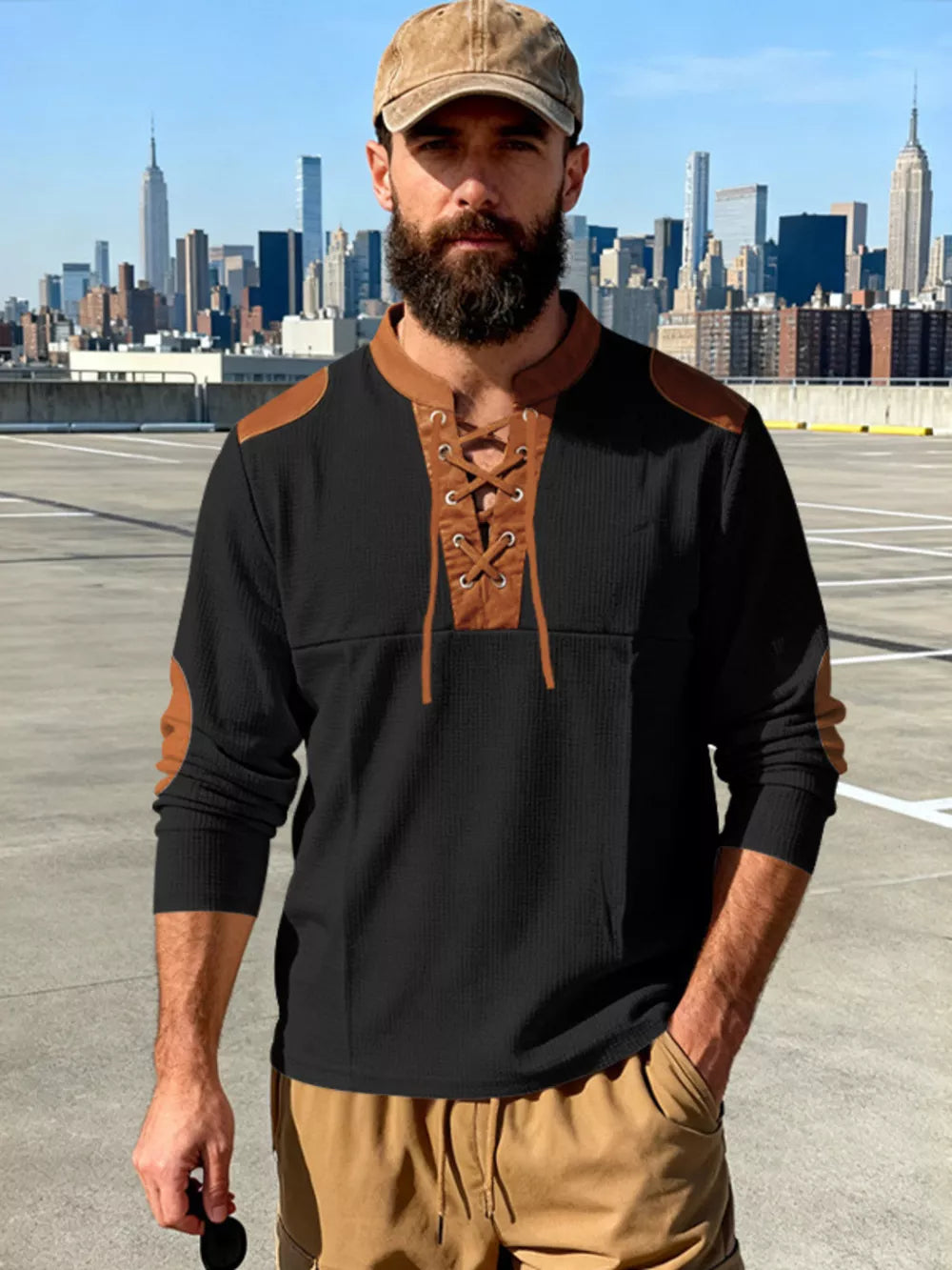 Black long-sleeve men's t-shirt with lace-up neckline and brown accents.