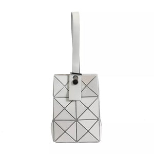 White mini geometric panel tote with a single handle and snap closure.