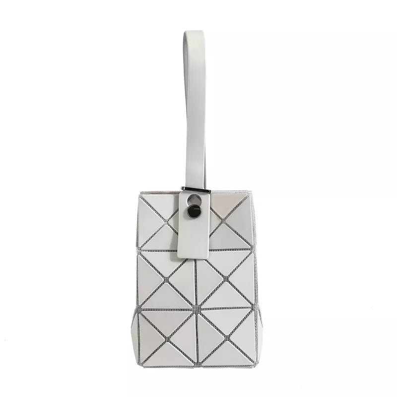 White mini geometric panel tote with a single handle and snap closure.