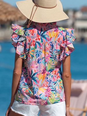 Tropical floral print cotton blouse with ruffled short sleeves and a high neckline.