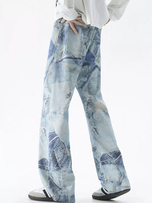Men's light blue distressed wide-leg jeans with patchwork denim detail