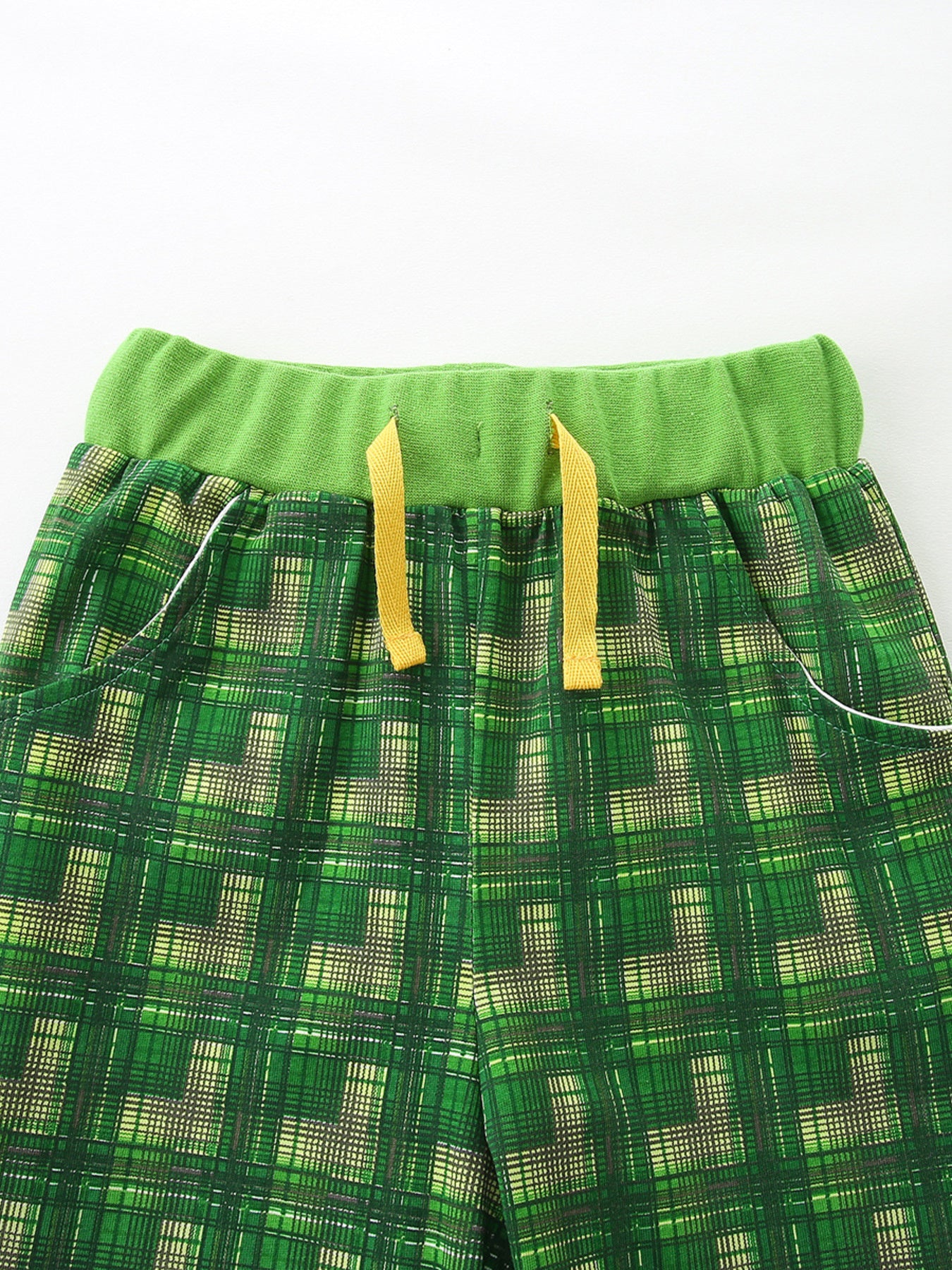 Baby shorts with green plaid pattern and yellow drawstring detail