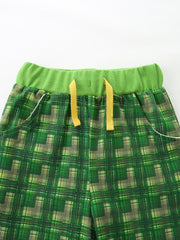 Baby shorts with green plaid pattern and yellow drawstring detail