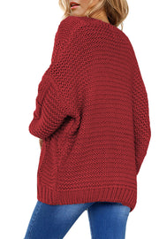 Burgundy cable knit cocoon cardigan with open front and relaxed fit.