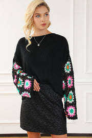 Black knit pullover sweater with colorful granny square crochet sleeves and boat neck.