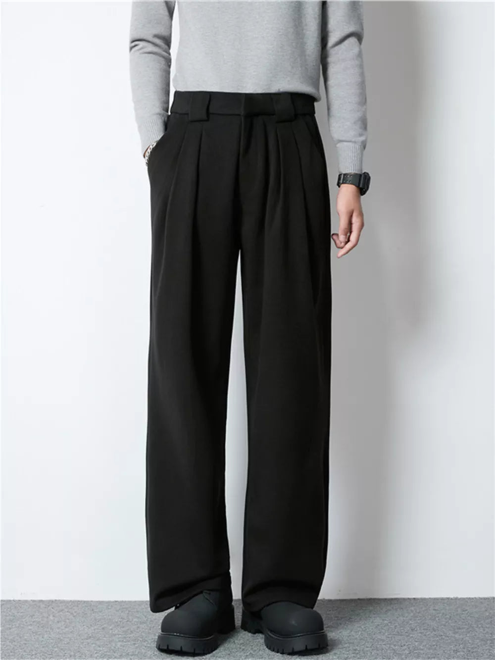 Men's black wide-leg pleated dress pants with a relaxed fit.