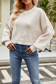 Boxy ribbed knit sweater in beige with crewneck and dropped shoulders.