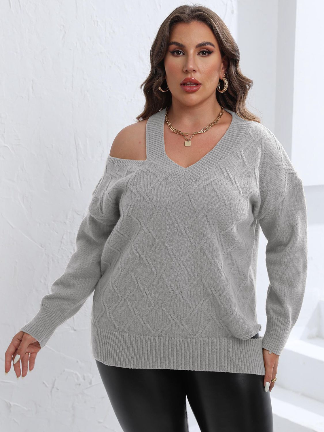 Light gray diamond knit sweater with asymmetric shoulder and V-neck.
