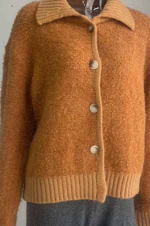Textured bouclé collar cardigan in tangerine with button front and ribbed hem.