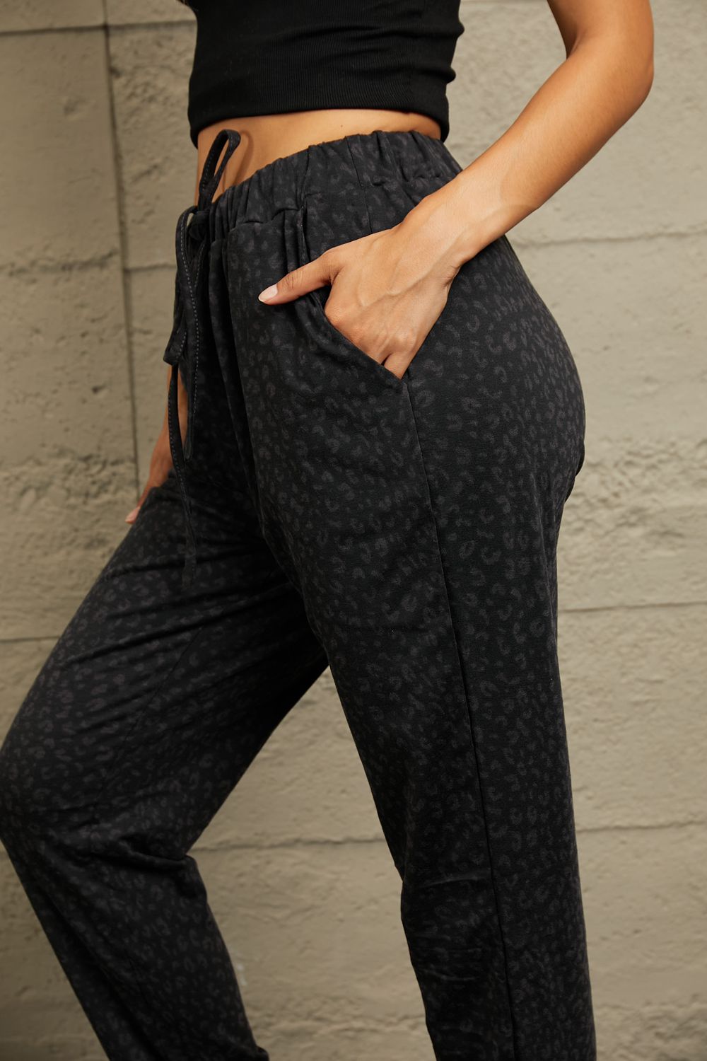 Shadow Leopard Relaxed-Fit Drawstring Trousers in Black with side pockets.