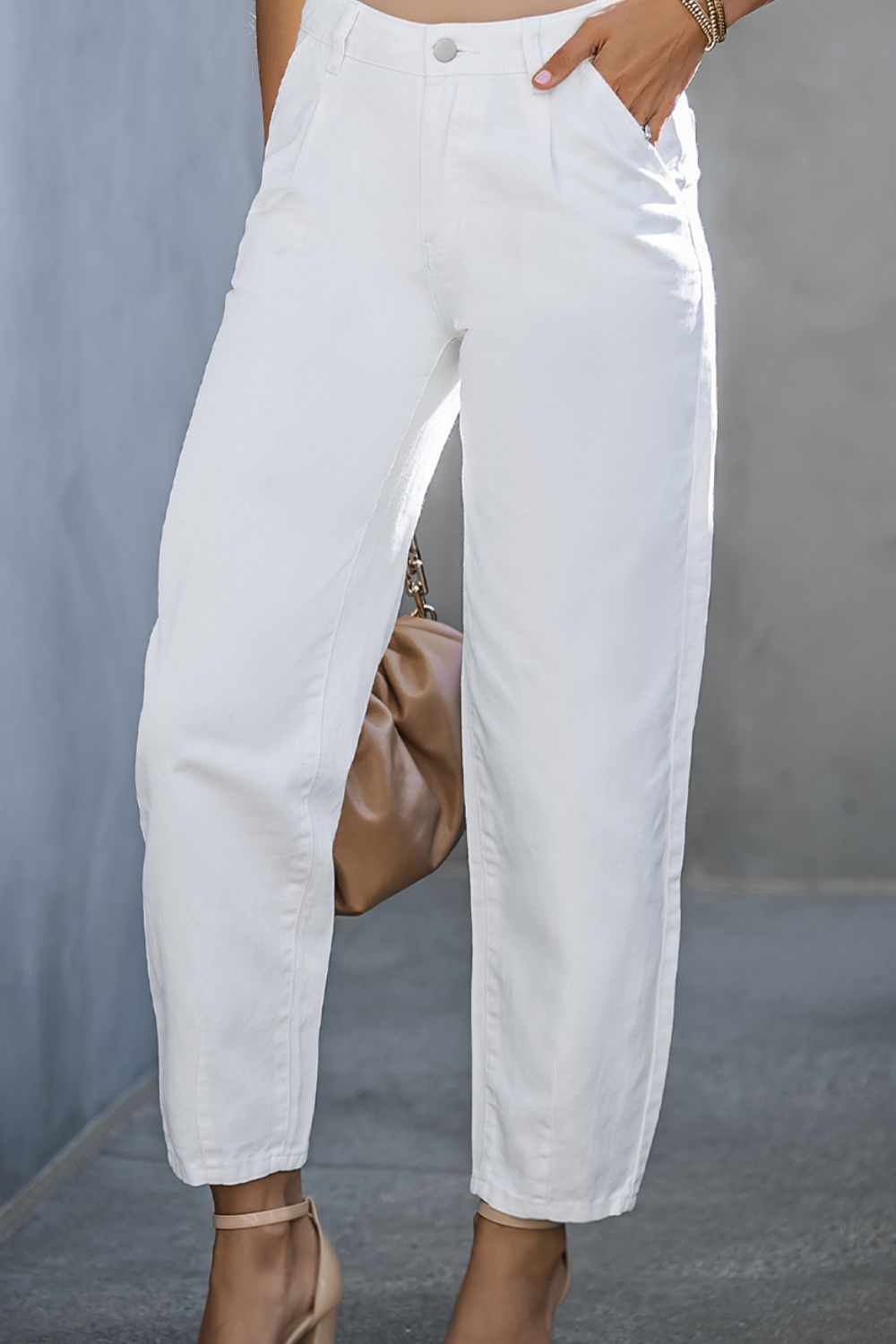 White pleated front straight leg jeans with a cropped length.